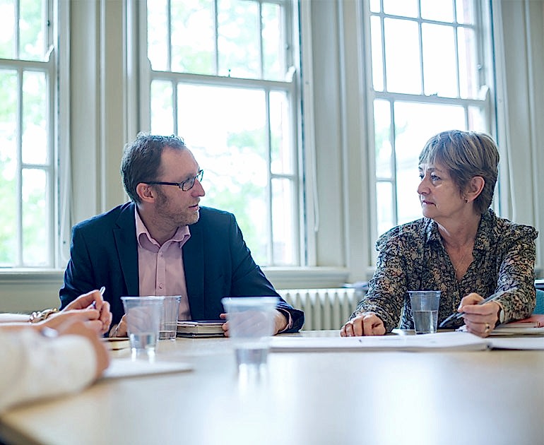 A man and a woman discussing business in the Seminar Room, one of our rooms for hire.
