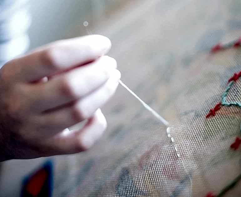 An image of a volunteer sewing as part of the Museum's Sew Engaging community project.