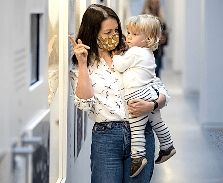 Two visitors, a mother and a child, in The MERL galleries.