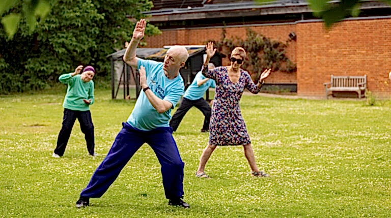 People taking part in a Tai Chi session in The MERL garden
