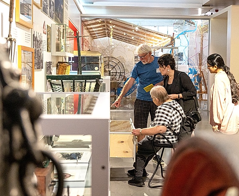 a small group looking at a display in the MERL galleries