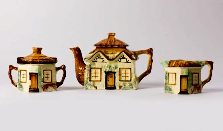 Three teapots from the MERL collection, modeled after cottages