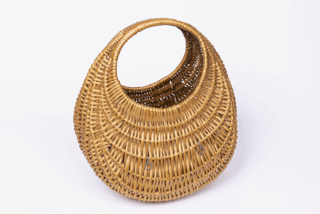 This poultry basket, Ose (MERL 60/770), was purchased by The British Council in the mid 1940s from Highland Home Industries in Edinburgh. Baskets of this type, which are traditionally made of split willow, appeared in illuminated manuscripts in the twelfth century and were turned into fashion accessories in the 1960s, when Brigitte Bardot used one as a handbag.
